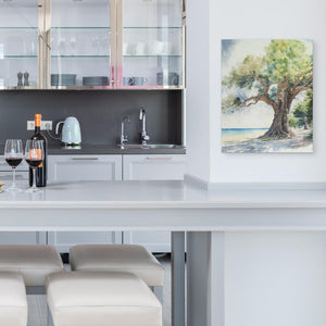 a white kitchen with a painting on the wall