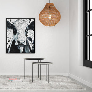 a living room with a cow painting on the wall