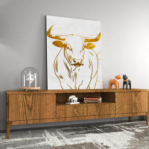 a picture of a cow on a wall above a wooden cabinet