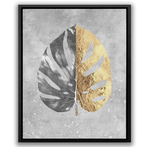 a gold and silver leaf on a gray background