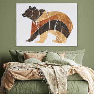 a painting of a bear on a wall above a bed