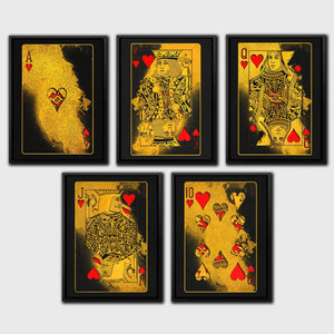 a set of four gold playing cards with hearts