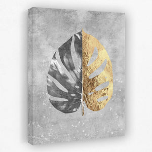 a gold and black leaf on a gray background