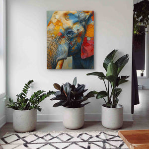 a painting of an elephant on a white wall next to potted plants