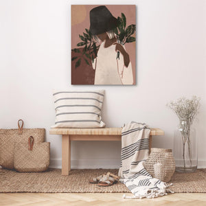 a picture of a woman with a hat on a wall above a bench