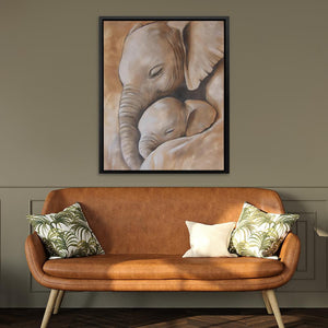 a painting of a baby elephant is hanging above a couch