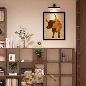 a picture of a bull on a wall above a chair