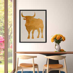 a picture of a bull on a wall above a table