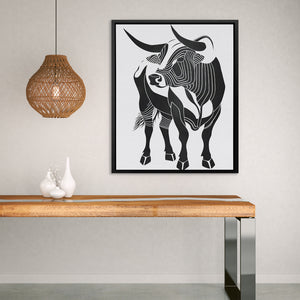 a picture of a cow on a wall above a table