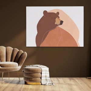 a brown bear sitting on top of a wooden floor next to a chair