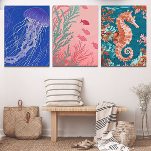 three paintings of sea animals on a wall