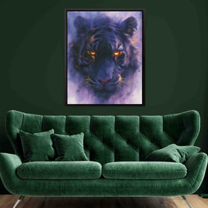 a living room with a green couch and a painting of a tiger