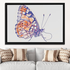 a picture of a butterfly on a wall above a couch