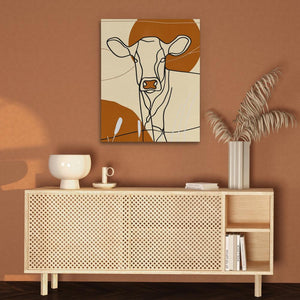 a painting of a cow on a brown wall