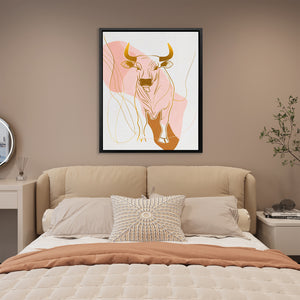 a picture of a bull on a wall above a bed