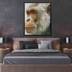 a picture of a monkey on a wall above a bed