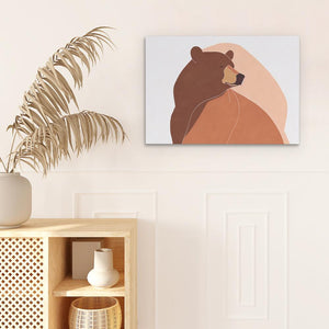 a brown bear sitting on top of a wooden shelf next to a potted plant