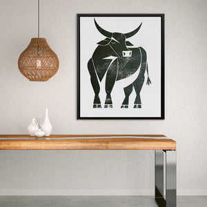 a picture of a bull on a wall above a table