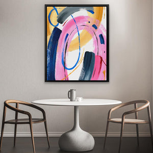 a table with two chairs and a painting on the wall