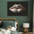 a painting of a woman's lips on a wall above a bed