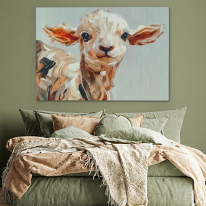 a painting of a baby cow on a wall above a bed