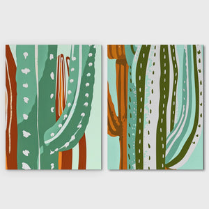 a couple of paintings of cactuses on a wall