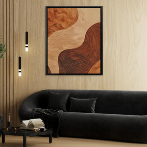 a living room with a black couch and a painting on the wall