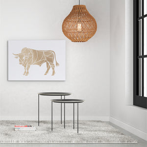 a living room with a table and a cow print on the wall