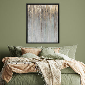 a bed with a green comforter and a painting on the wall