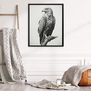 a black and white photo of an eagle sitting on a branch