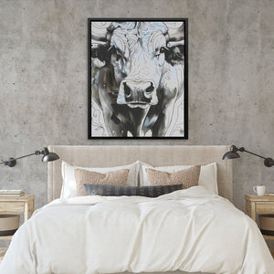 a picture of a cow on a wall above a bed