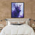 a painting of a deer is hanging above a bed