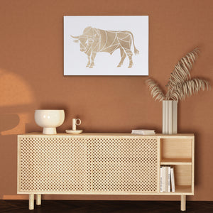 a picture of a cow on a wall above a cabinet