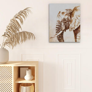 a picture of an elephant on a wall next to a potted plant