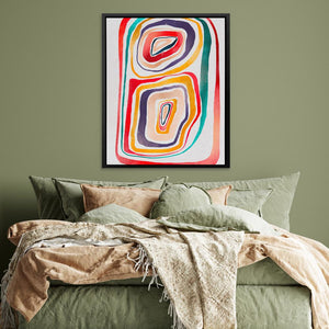 a bed with a green comforter and a painting on the wall