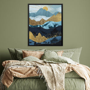 a bed with a green comforter and a painting on the wall