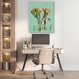 a home office with a painting of a cow on the wall