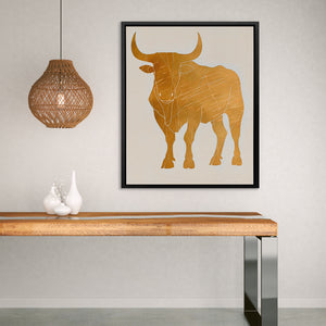 a picture of a bull on a wall above a table