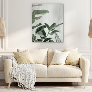 a living room with a white couch and a painting on the wall