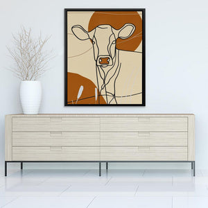 a picture of a cow on a wall above a dresser