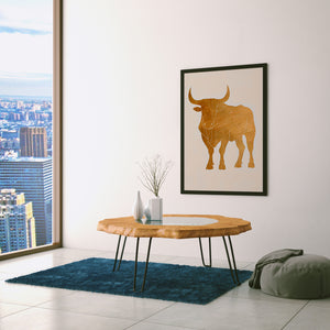 a living room with a table and a picture hanging on the wall